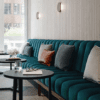 Custom upholstered banquette seating in a modern hospitality interior, Australian made commercial furniture
