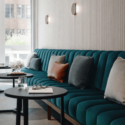 Custom upholstered banquette seating in a modern hospitality interior, Australian made commercial furniture