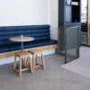 Log Booth commercial banquette seating with upholstered backrest and timber base in hospitality interior