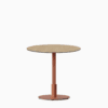 Round dining table with compact‑laminate top and metal pedestal base.