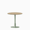 Round dining table with compact‑laminate top and metal pedestal base.