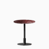 Round dining table with marble top and metal pedestal base.