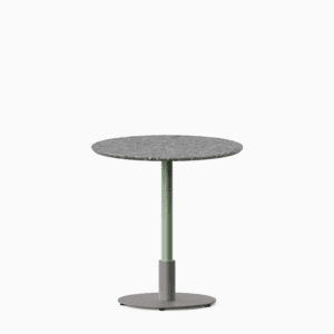 Round dining table with terrazzo top and metal pedestal base.