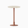 Round bar table with terrazzo top and metal pedestal base.