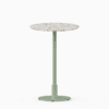 Round bar table with terrazzo top and metal pedestal base.