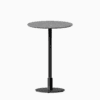 Round bar table with terrazzo top and metal pedestal base.