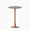 Round bar table with terrazzo top and metal pedestal base.