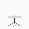 Round terrazzo table with speckled stone top and green aluminium base.