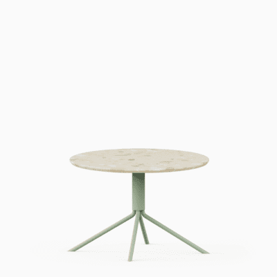 Round terrazzo table with speckled stone top and green aluminium base.