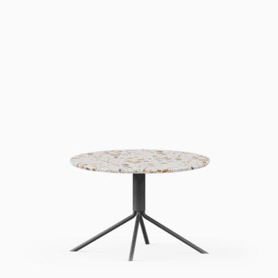 Round terrazzo table with speckled stone top and green aluminium base.