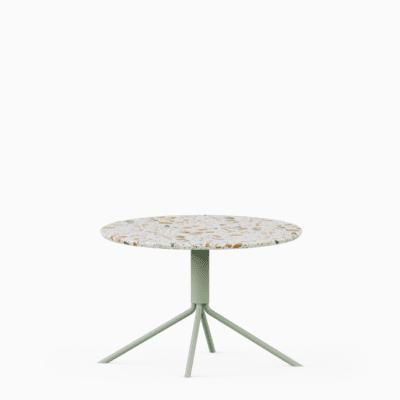 Round terrazzo table with speckled stone top and green aluminium base.
