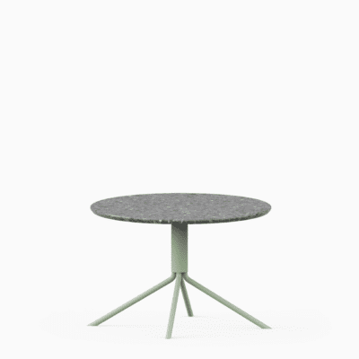 Round terrazzo table with speckled stone top and green aluminium base.