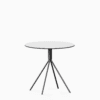 Round compact‑laminate dining table with aluminium base.