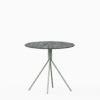 Round compact‑laminate dining table with aluminium base.