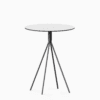 Round compact‑laminate dining table with aluminium base.