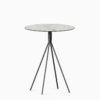 Round compact‑laminate dining table with aluminium base.