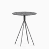 Round compact‑laminate dining table with aluminium base.